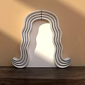 Modern Sculptural Wavy Two Tone Blue And White Mirror On Wooden Surface With Light Shadows