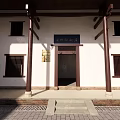 Traditional Chinese Architectural Entrance With Wooden Pillars Stone Steps And Plaque