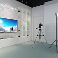 Modern Public Office Space With Broadcast Desk HNlive Logo Hexagonal Backdrop And Professional Lighting
