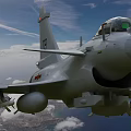 Two Military Fighter Jets Flying In Blue Sky With White Clouds Over Land And Ocean