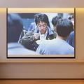 Projection Monitoring Live Feed Displayed on Large Screen Showing Group Interaction