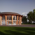 Traditional Ancient Building Featuring Circular Roof Wooden Frame Glass Walls Surrounded By Grassland And Trees