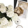 Decorative Ornament Set with White Hydrangea Glass Vase Books Black Bowl Gold Plate and Candles