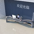 Modern Reception Desk With Curved Design Blue Wall Welcome Sign Computer Potted Plant And Receptionist
