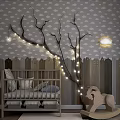 Cozy Baby Crib Room with Branch String Lights Cloud Wallpaper and Wooden Rocking Horse