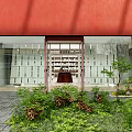 Modern Shopping Mall Store With Red Exterior Large Glass Windows And Green Plants