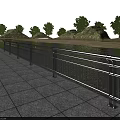 Stainless Steel Railing Along Waterfront Roadside With Stone Pavement And Green Trees
