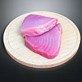 Fresh Tuna Meat Pieces Displayed On Round Wooden Cutting Board