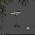 Modern Minimalist Table Lamp With Golden Pole Curved Shade Warm Glowing Light And Green Leaves