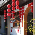Traditional Chinese Courtyard With Red Lanterns Wooden Archway Calligraphy Scroll And Yellow Flowers