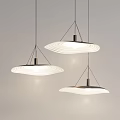 Modern Hanging Pendant Lights With Circular Wavy Shades And Metal Frames Illuminated In Minimalist Space
