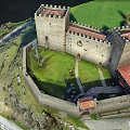 Medieval Castle Architecture With Stone Walls Towers On Green Hill And Path