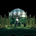 Halo Luxe Scene With Woman Standing Among Lit Bamboo And Circular Arch On Green Grass
