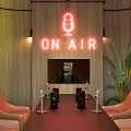 Modern Interior With Green Wavy Neon Wall ON AIR Sign Black Table Brown Chairs Plants