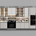 Modern Kitchen Cookware With White Cabinets Black Appliances And Marble Countertop