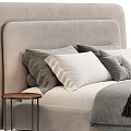 Double Bed with Upholstered Headboard and White Gray Pillows on Neutral Bedspread beside Nightstand