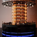Modern Stylish Circular Bar Counter With Backlit Liquor Racks Warm Hanging Lights And Bar Stools