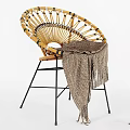 Round Wicker Rattan Chair With Knitted Blanket And Black Metal Legs