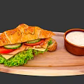 Tasty Croissant Sandwich With Lettuce Tomato Cucumber Ham And Cheese On Wooden Tray With Sauce
