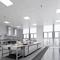 Commercial Kitchen Interior With Stainless Steel Appliances Work Counters And Large Windows