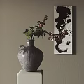 Gray Vase with Fresh Flowers on White Pedestal Against Beige Wall and Black White Abstract Painting