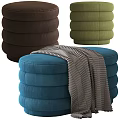 Multicolored Stacked Round Ottomans in Orange Blue Green with Soft Gray Blanket