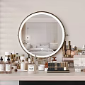 Elegant Perfume Cosmetics Display On Vanity Table With Round Mirror And Skincare Bottles