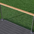 Outdoor Railing With Metal Cable Design Wooden Handrail Gray Wooden Deck And Green Grass Background