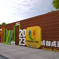 Group Sitting on Yellow Bench with Green Trees Blue Display Boards at New City University