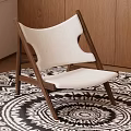 Modern Wooden Frame Accent Chair With White Upholstered Seat On Black And White Patterned Rug