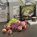 Fresh Grapes and Peaches on a Glass Plate with Books Vase and Mug in Background