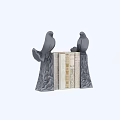 Black Bird Shaped Bookends Holding Books With Various Colors And Designs