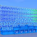 Outdoor Colorful Windmill Art Installation With Blue Green Blades And Blue Base Structure