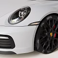 White Porsche Sports Car With Black Alloy Wheels And Sleek Front Design