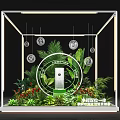 Artistic Floral Display Installation With Green Plants Flowers And Lighting In Glass Case
