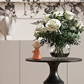 White Rose Bouquet In Clear Glass Vase With Orange Figurine On Black Round Table