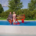 Red Landscape Seat With Two People Sitting By Waterfront Blue Sky And Trees