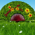 Green Fan Shaped Decorative Bush With Red Yellow Flowers In Grass Field