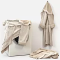 White Washing Machine With Freshly Laundered Soft Towels And Hanging Robes