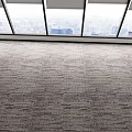 Carpeted Floor in Bright Room With Large Windows and Distant City Skyline View