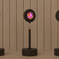 Modern Black Floor Lamp on Round Table with Warm Orange Glow against Vertical Striped Wall