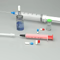Medical Supplies Including Syringe Vial And Colorful Capsules On White Surface
