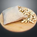 Fresh Peanuts Spilled From Burlap Sack On Round Wooden Plate