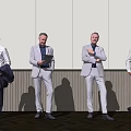 Business Men In Formal Attire Standing With Tablet And Coat Against Gray Wall