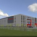 Modern Industrial Factory Building With Gray Exterior Red Accents Large Windows Lawn And Cars