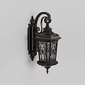 Vintage Black Metal Wall Lamp With Ornate Design And Glass Shade Emitting Warm Light