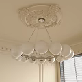 Classic Chandelier With White Globe Bulbs Metal Frame And Carved Ceiling Detail