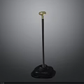 Sturdy Standing Equipment With Textured Black Base Black Pole And Golden Round Top