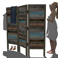 Woman Wearing White Towel Standing on Green Grass Next to Wooden Screen with Hanging Clothes