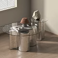 Modern Glass Coffee Table With Curved Silver Metal Base Books Decorative Stone And Lamp